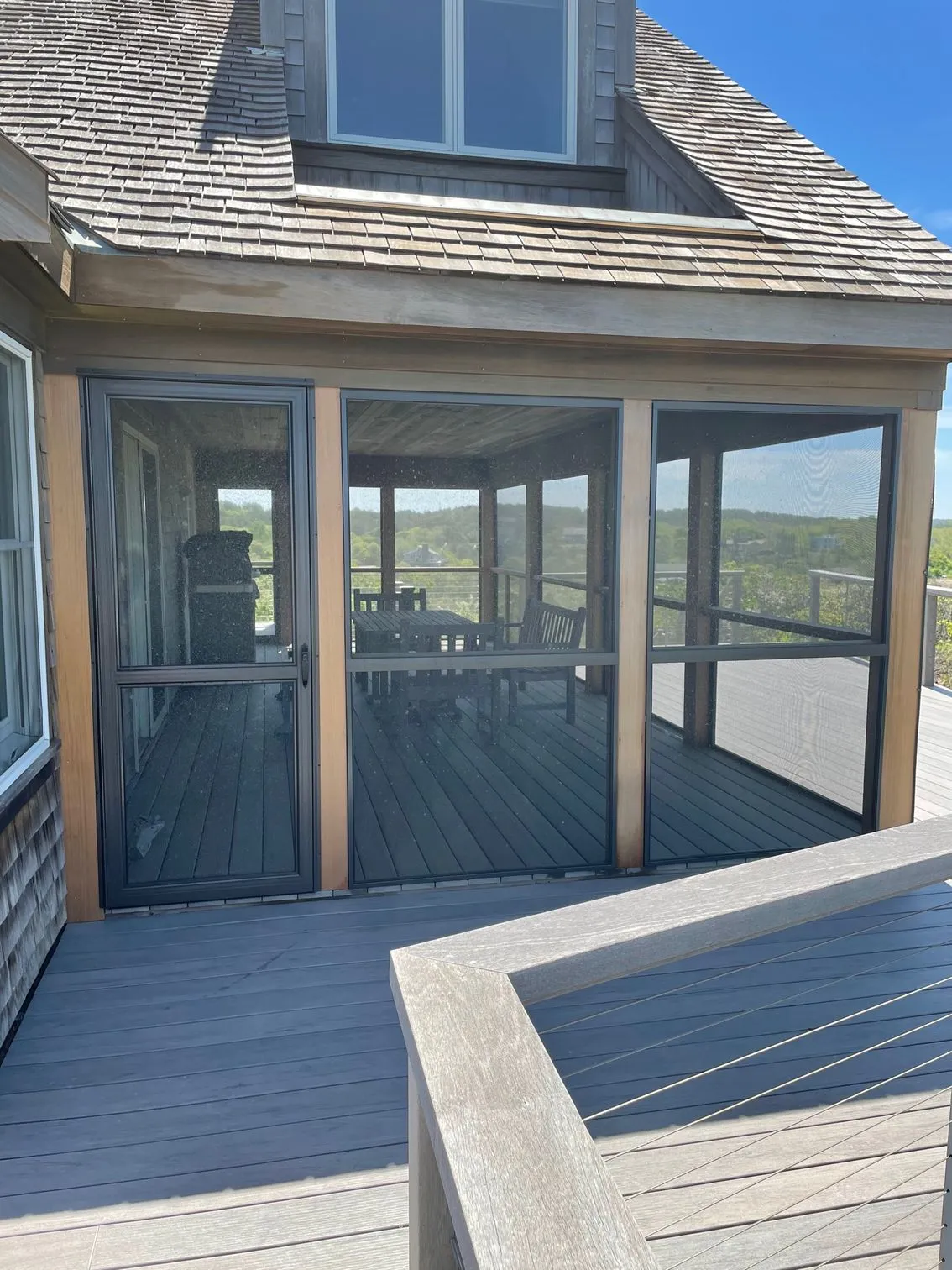 there is a screened in porch on the side of a house