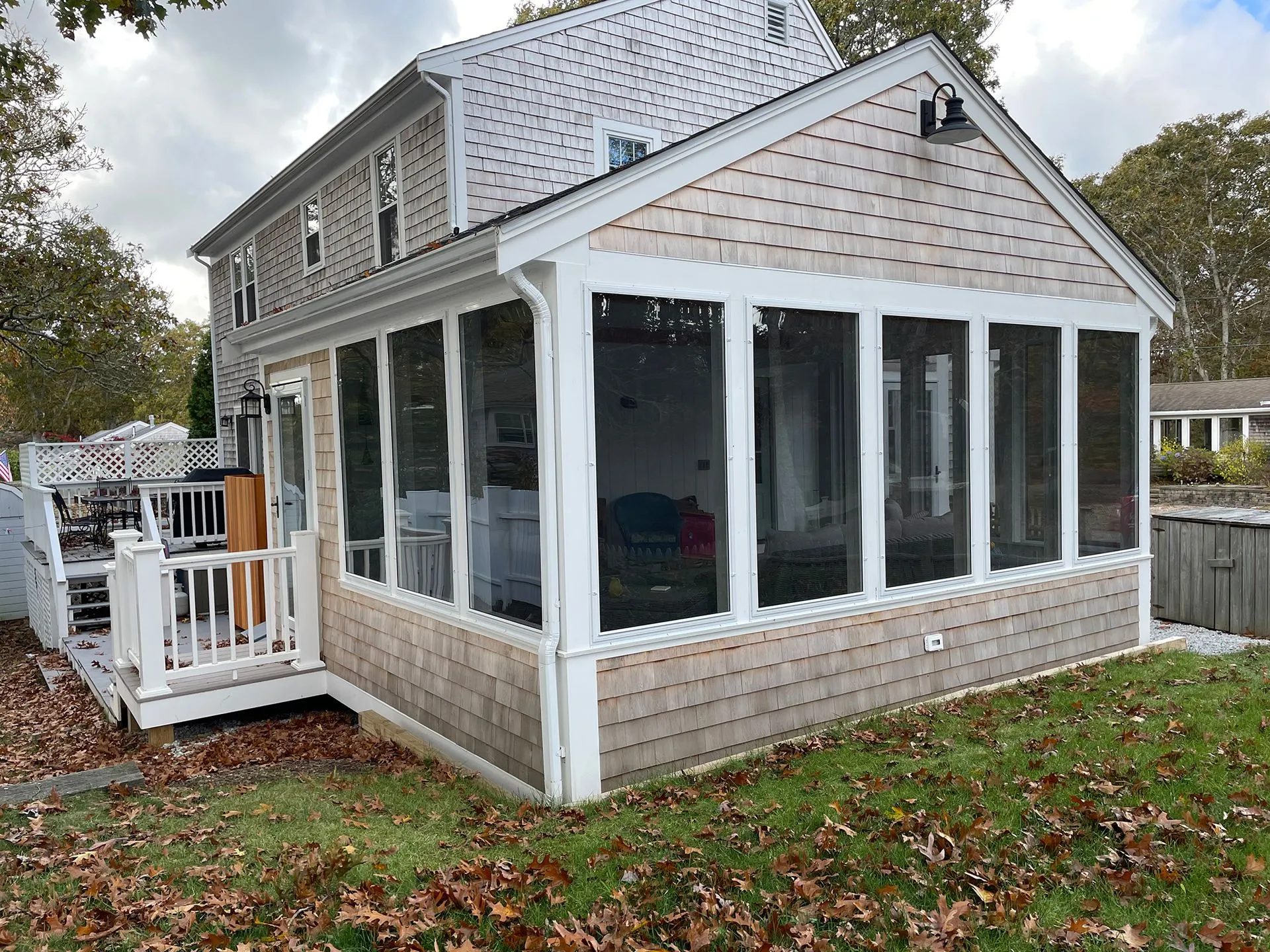 a screened in porch is attached to the side of a house
