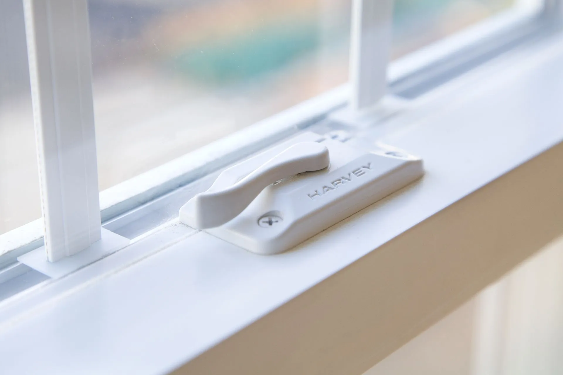 a close up of a window with a white handle on it