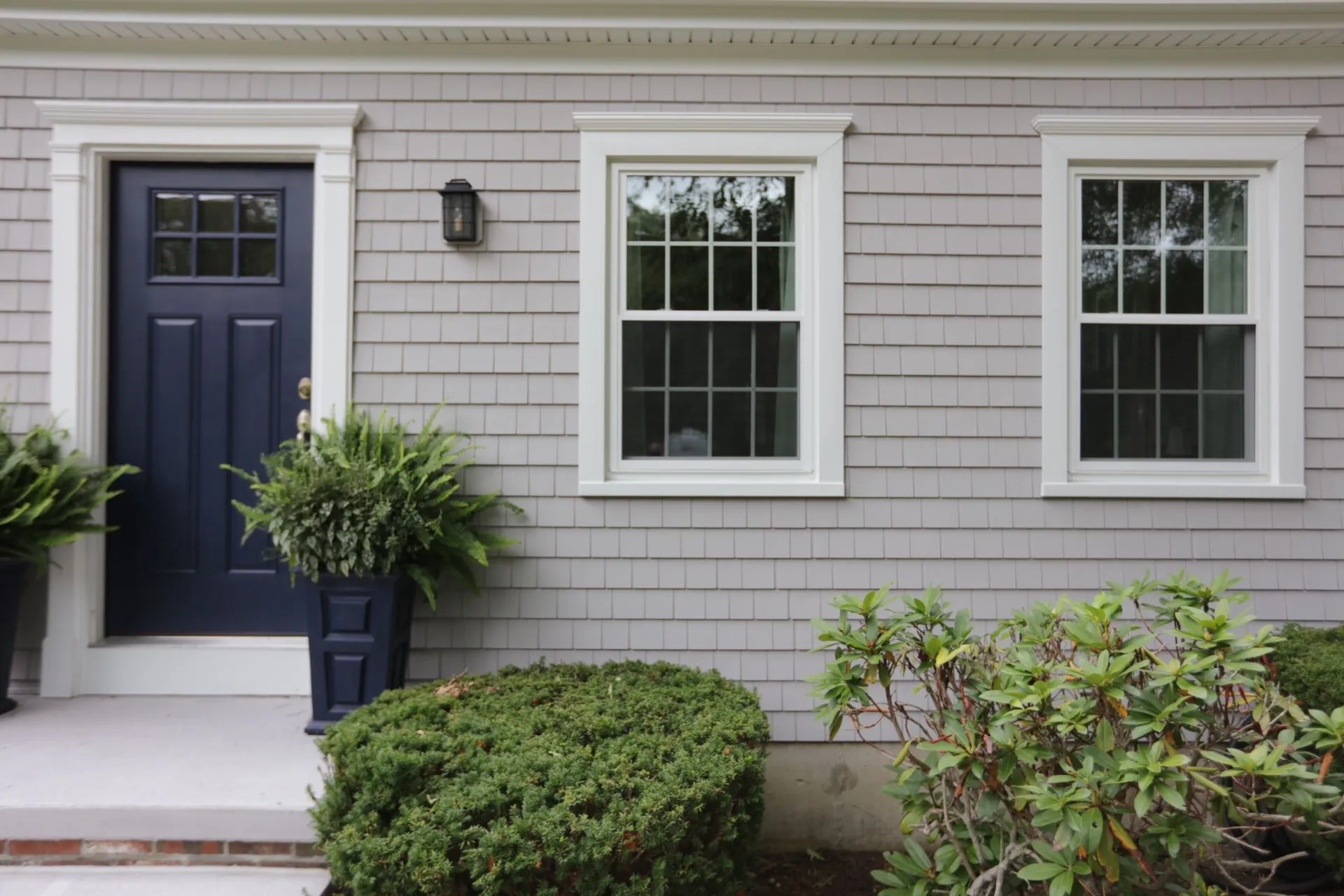 a house with a blue door and white windows