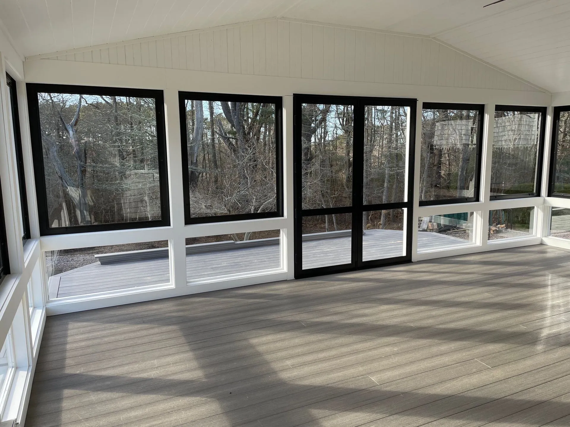 an empty room with a lot of windows and a wooden floor