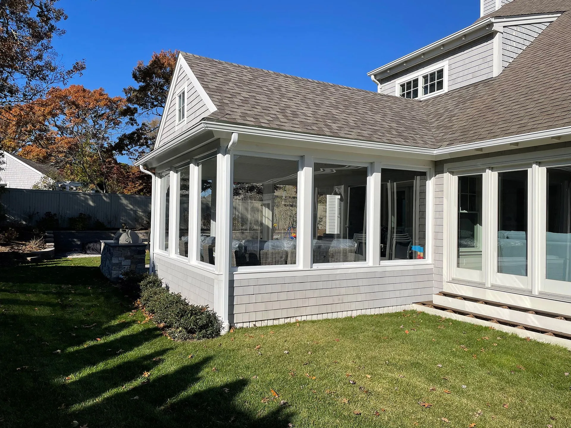 a house with a screened in porch and a lot of windows