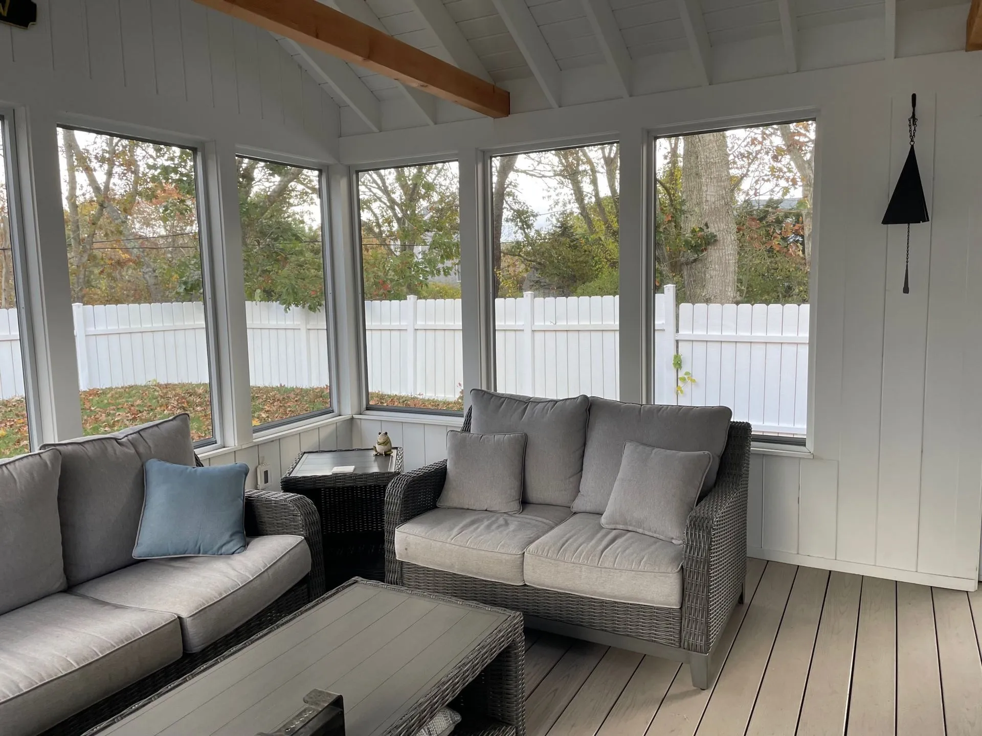 a living room with a couch, chair, table and lots of windows