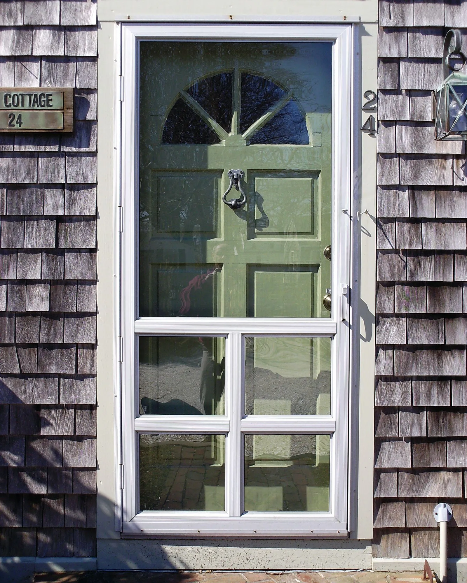 a green door with the number 24 on it