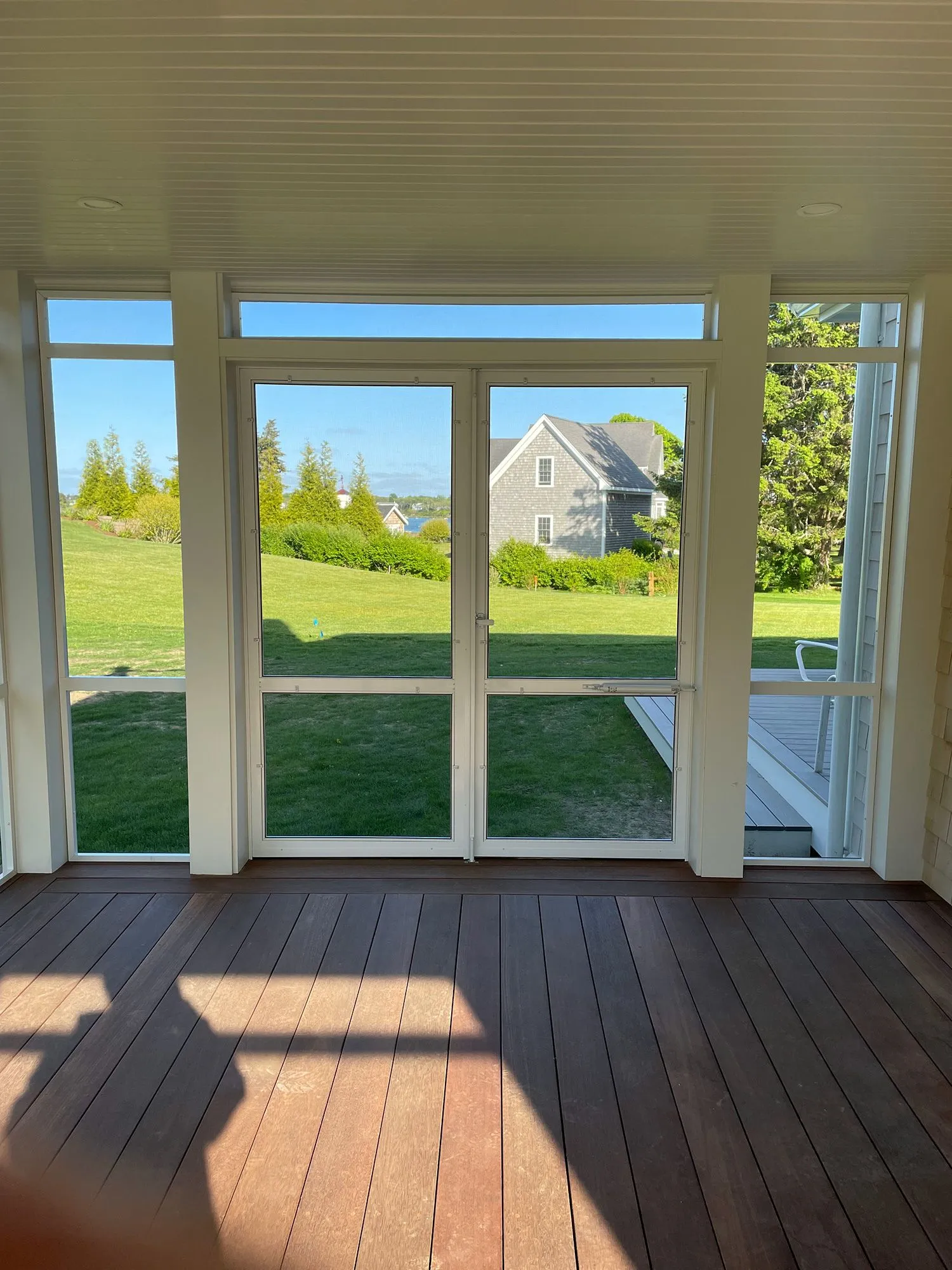 a room with a lot of windows and a wooden floor