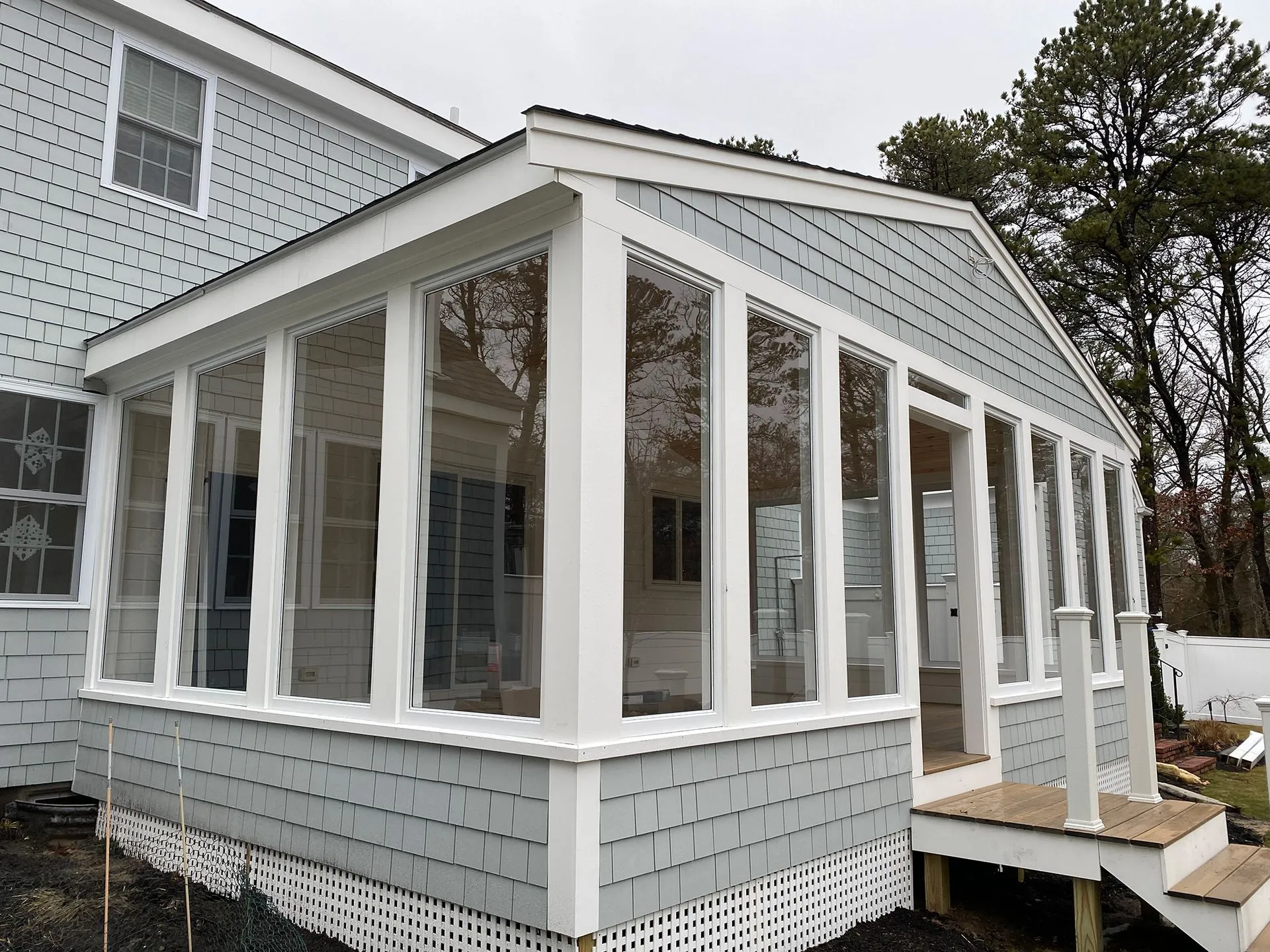 a screened in porch on the side of a house